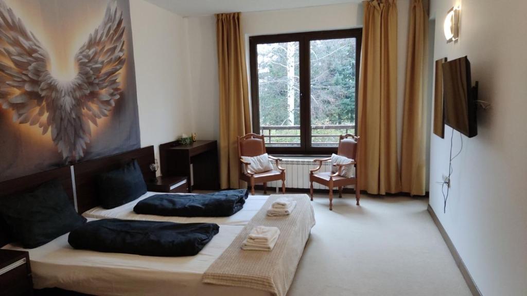 een woonkamer met een bed en een raam bij Terra SP apartments-Razlog in Razlog