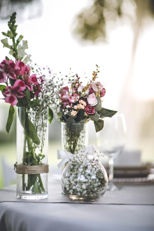 two vases filled with flowers sitting on a table at Il Vigneto Resort in Menfi