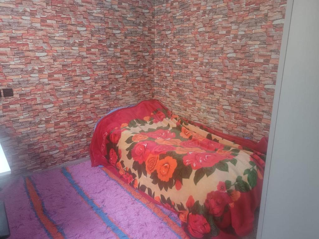a bedroom with a bed in a brick wall at بيت مع وجبة إفطار لمشجعي كأس الأمم الأفريقية in Fez