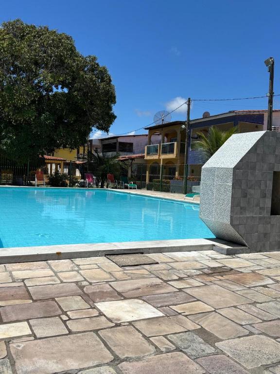 a large blue swimming pool in front of a building at Casa Sol e Mar in Tamandaré