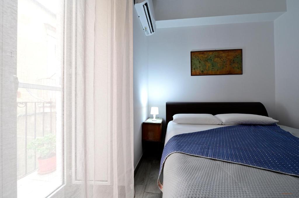 a bedroom with a bed and a large window at Il Cavalliere Bed & breakfast in Barletta