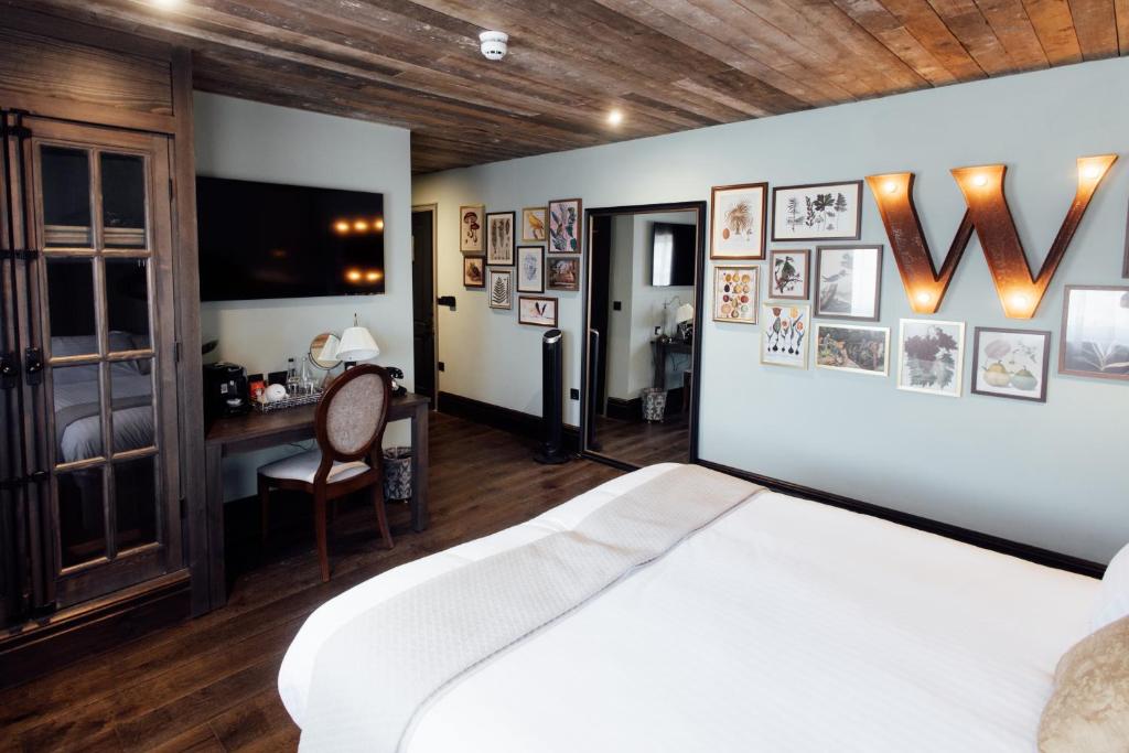 a bedroom with a white bed and a desk at The Wildings Northumberland in Morpeth