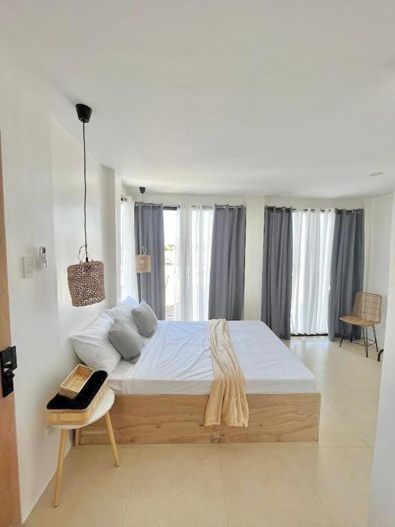 a bedroom with a large bed and a table at EB Home Apartment in Mactan Island