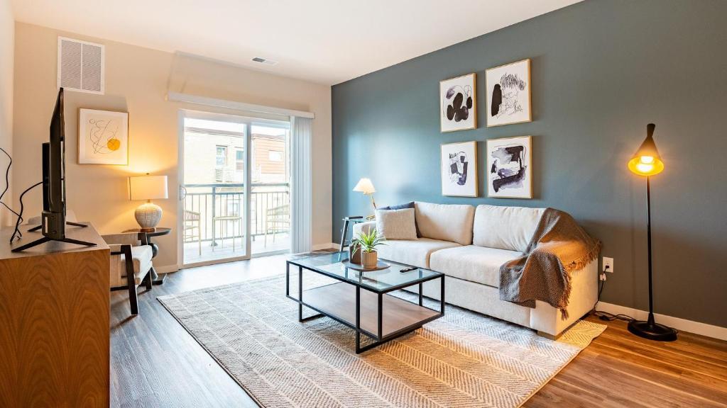 a living room with a couch and a table at Landing Apartments - The 55 Elm Club in Hartford