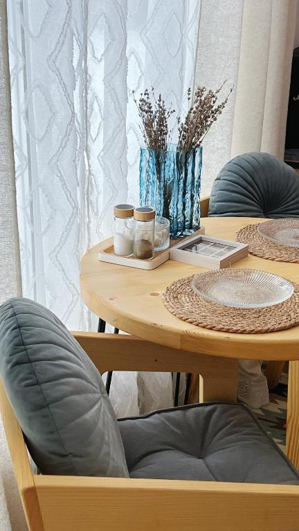 a wooden table with two chairs and a table with jars on it at Molfar in Yasinya