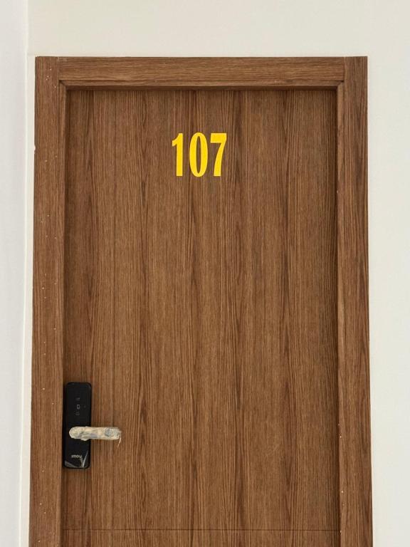 a wooden door with the number on it at Hôtel kairouan in Fez