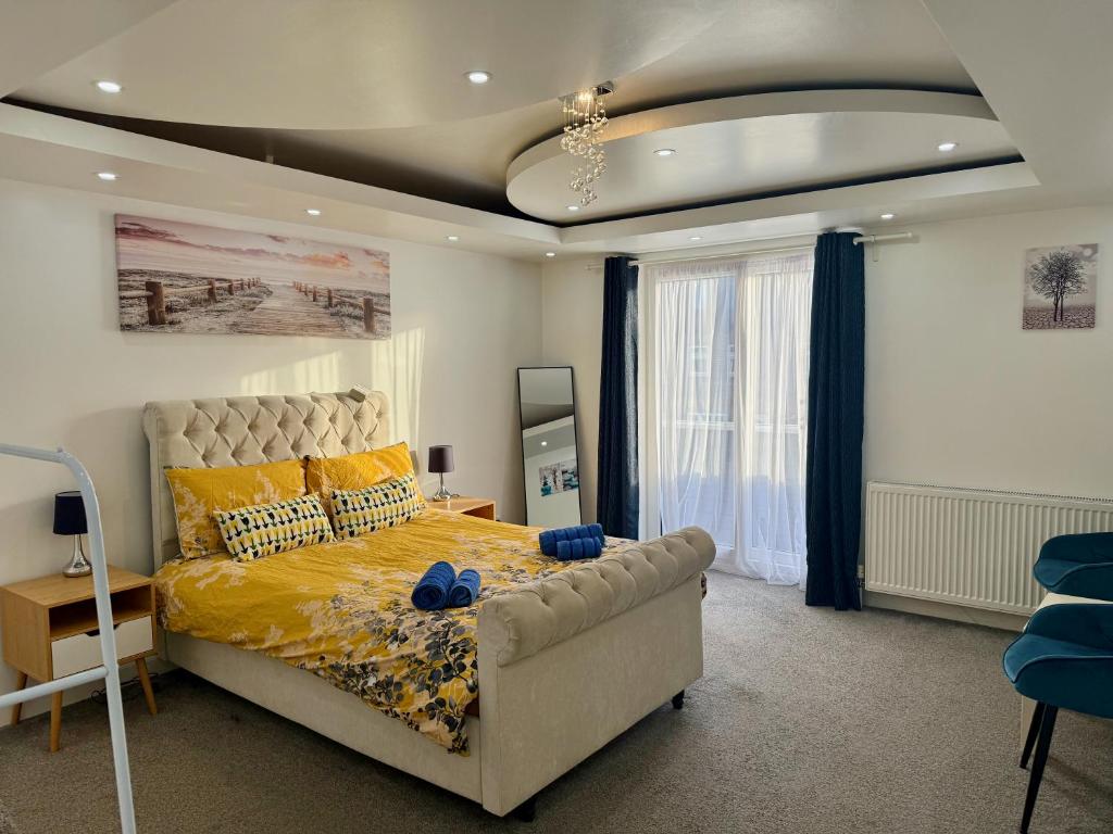 a bedroom with a bed with blue shoes on it at Modern Elegant Home in Portsmouth