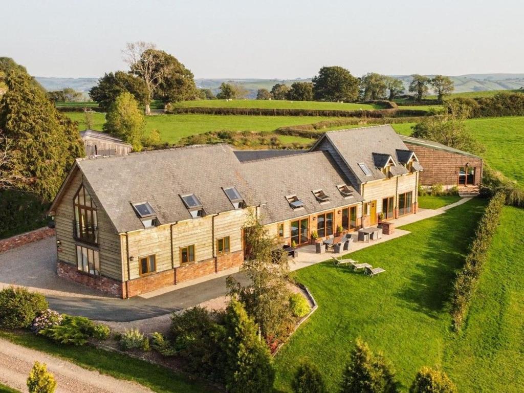 an aerial view of a large house in a field at Bedw Barn in Newtown