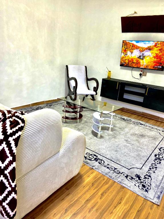 ein Wohnzimmer mit Sofa und Flachbildfernseher in der Unterkunft Teru in Nanyuki