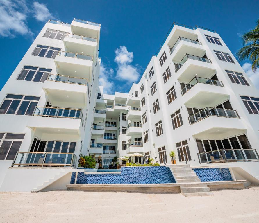 a white apartment building on the beach at Royal Kahal Beach Resort in San Pedro