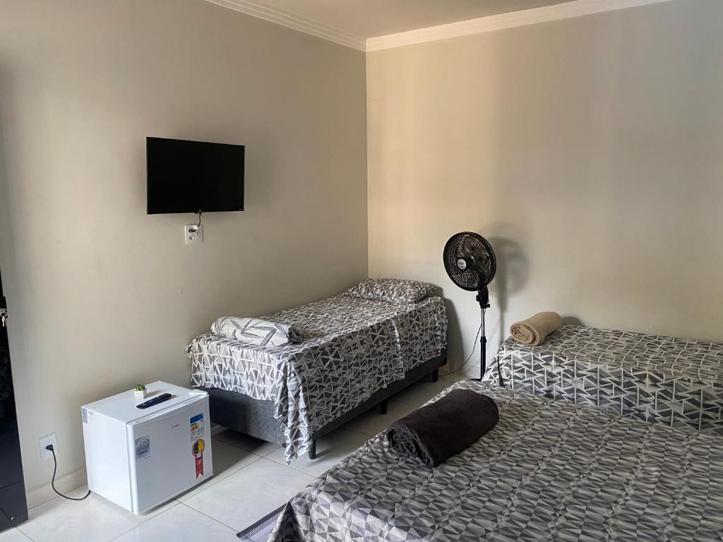 En eller flere senge i et værelse på Ibiza Inn Suítes Uberaba