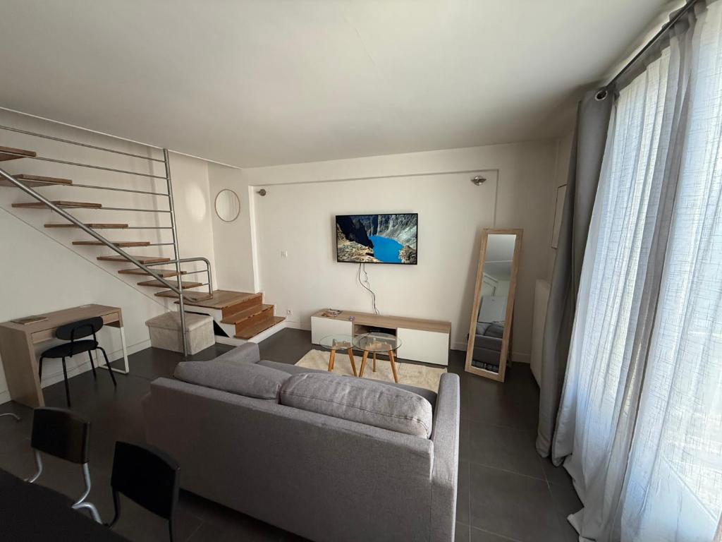 a living room with a couch and a staircase at Le Cosy duplex-4p-2beds-free parking in Grenoble