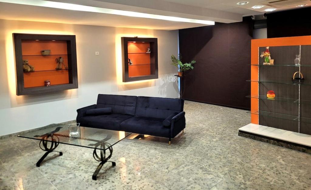 a living room with a couch and a glass table at La Friandise in Seppois-le-Bas