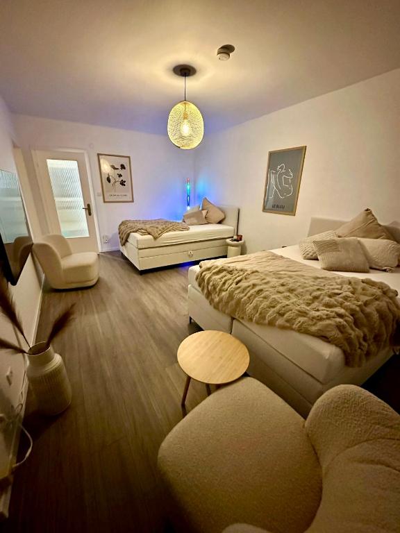 a bedroom with two beds and a couch at Little Royal in Garbsen