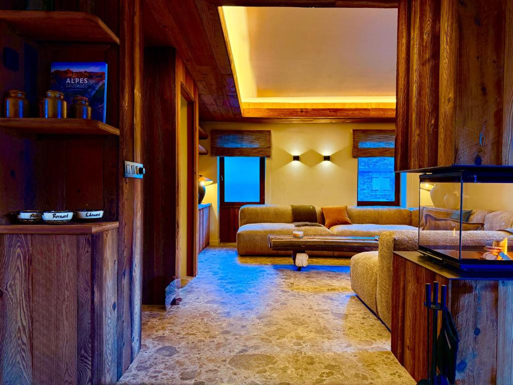 a living room with two couches and a couch at Chalet Oslo by Lodji in Saint-Marcel