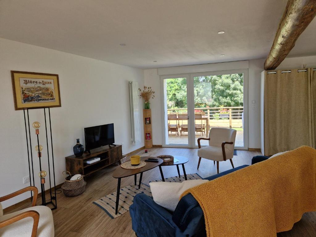 a living room with a couch and a table at Gite Bergamote in Champenoux