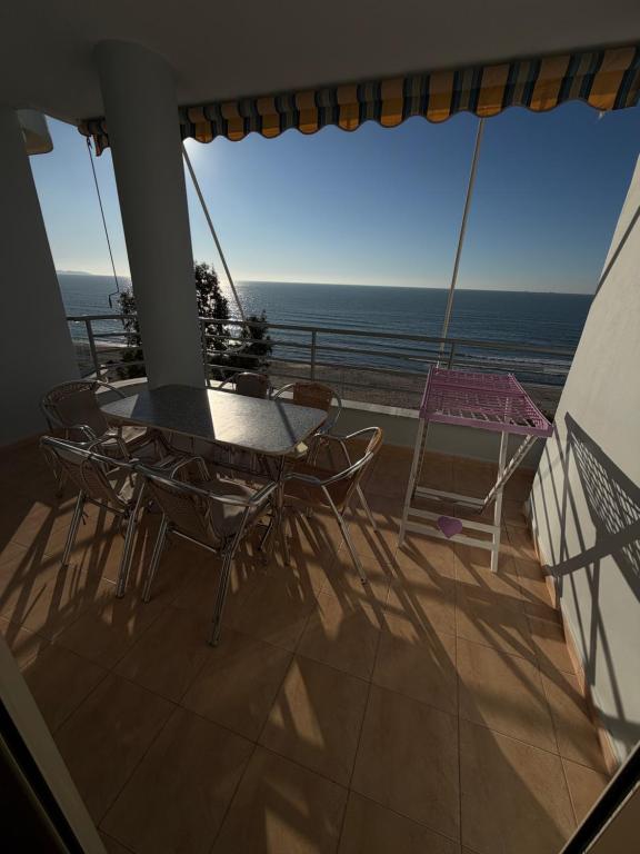 a balcony with a table and chairs and the ocean at Espana aparthotel in Durrës
