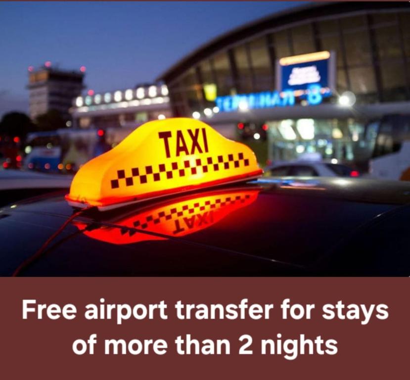 a taxi sign on the roof of a car at Baku Khatai Hotel & Restaurant in Baku