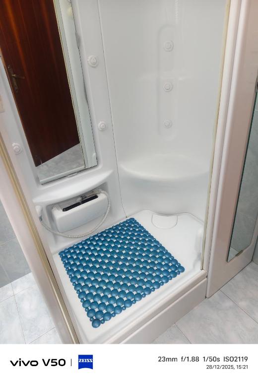 a small shower with a blue floor in a bathroom at AR lodges in Montecosaro