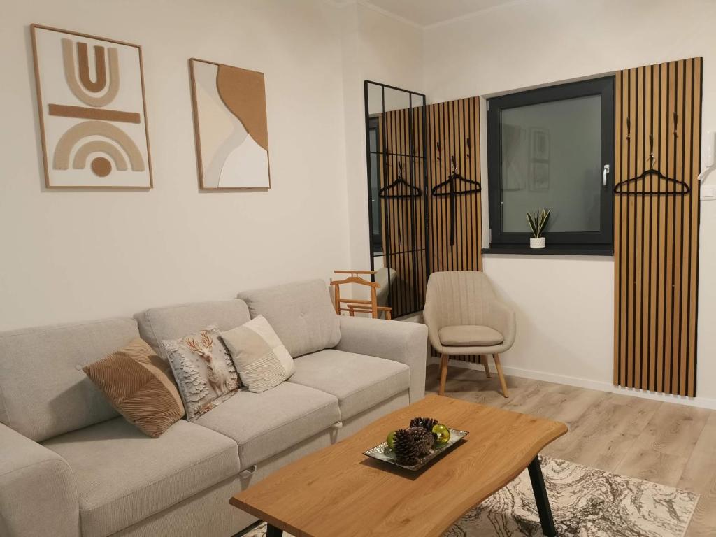 a living room with a couch and a table at River Apartman 1 in Odorheiu Secuiesc