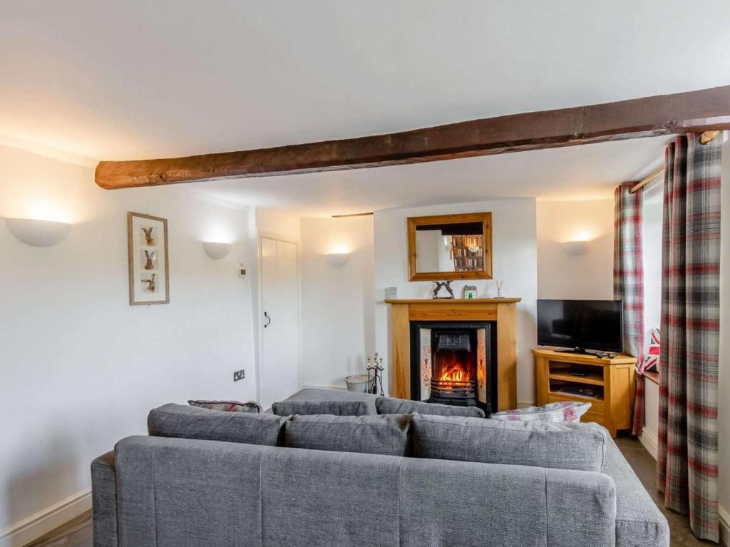 a living room with a couch and a fireplace at 2 Bed in Ambleside oc-89748 in Hawkshead