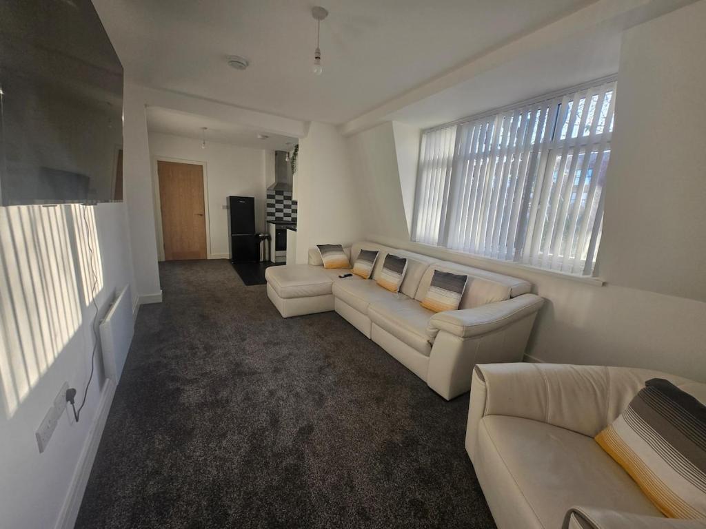 a living room with two couches and two windows at 1 Bed City Centre Apartment in Derby