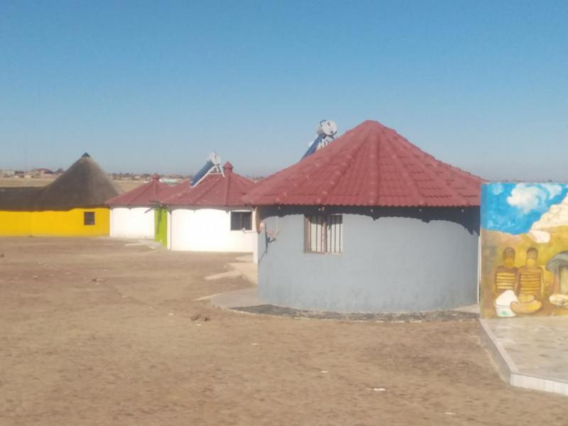 a group of buildings with a red roof at Bafokeng Palace in Mid-Ennerdale