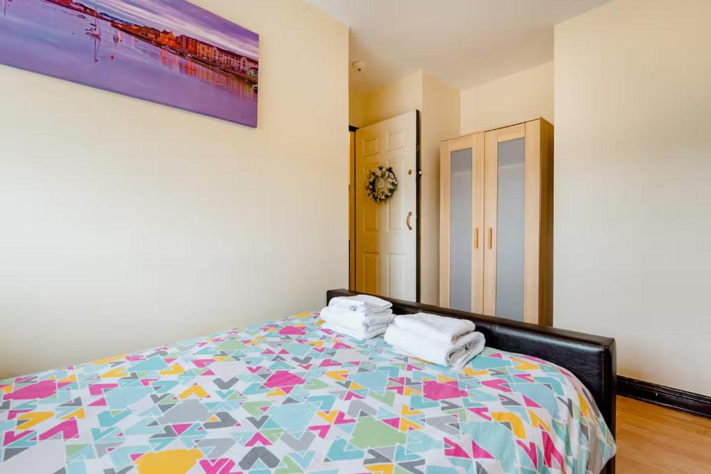 a bedroom with a bed with a colorful comforter at Bunratty Star in Dublin