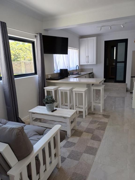 un salon avec un canapé et une cuisine dans l'établissement Cosy comfort, à George