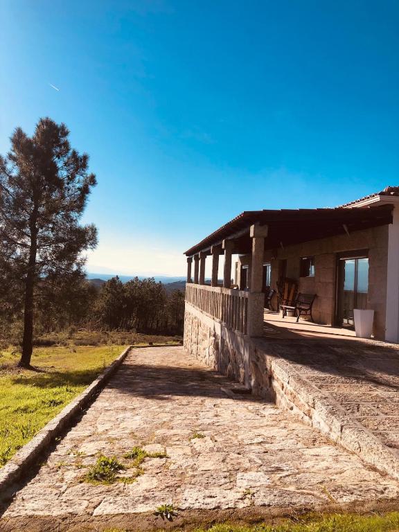 a building with a tree in front of it at Refúgio da Serra - Cottage House in Fornos de Algodres