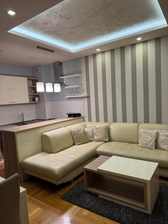 a living room with a couch and a table at Vila Ljubovic in Podgorica