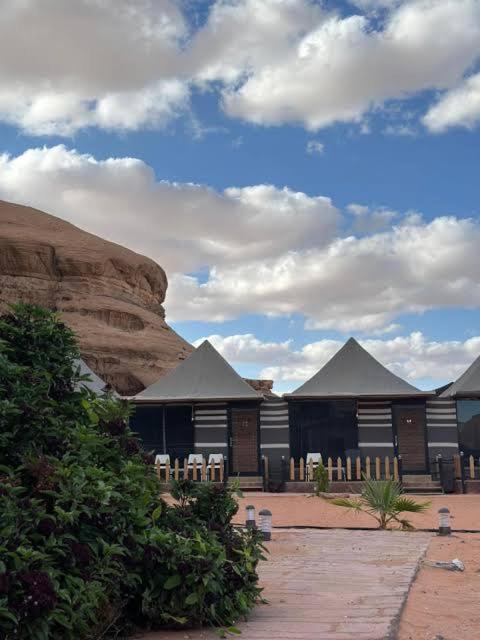 a group of buildings in the middle of a desert at Wadi Rum Salem Muhammad in Wadi Rum