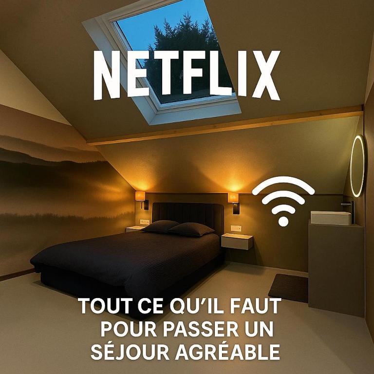 a bedroom with a bed with a window and a sign that reads notify at L'annexe 3 - Cosy studio Dole in Foucherans