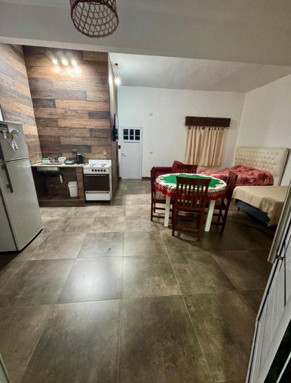 a kitchen and a living room with a table and a kitchen and a kitchen at Sueños de Mar in Mar del Tuyú
