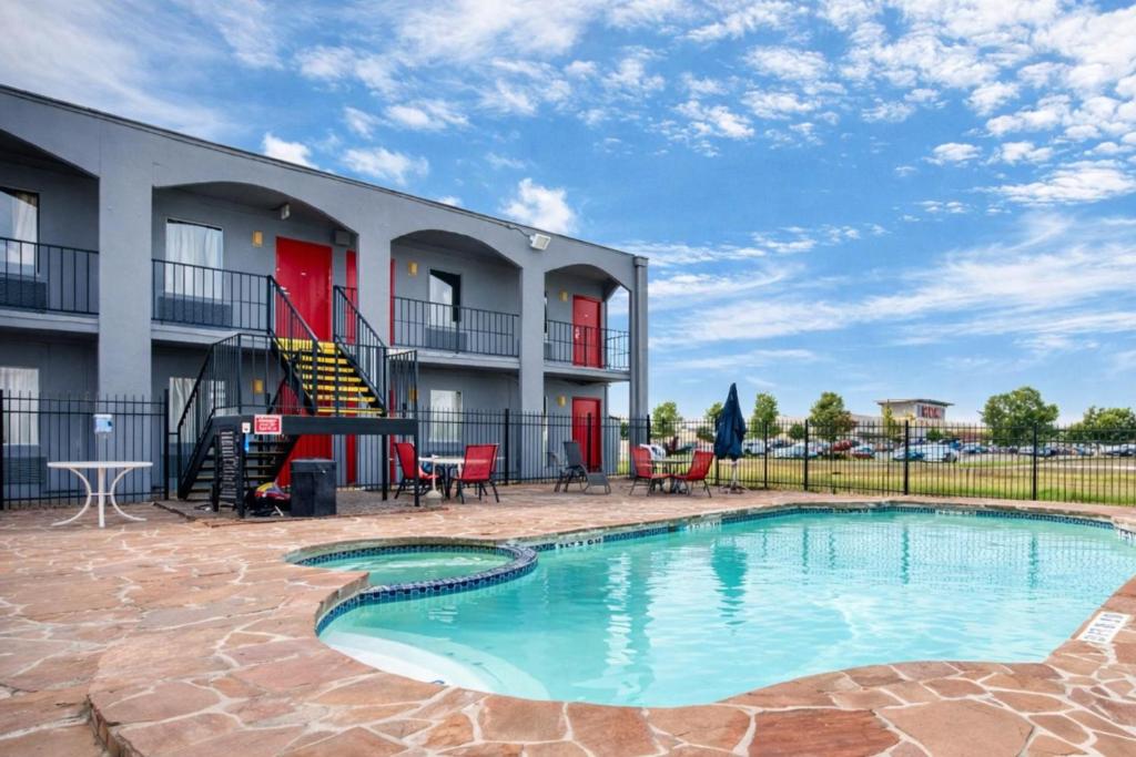 a swimming pool in front of a building at OYO Hotel San Antonio Lackland Air Force Base West in San Antonio