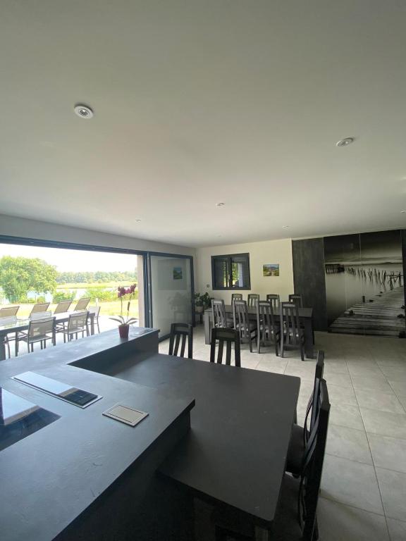 a large dining room with a table and chairs at Chambres d'hôtes bord de Saône in Lamarche-sur-Saône