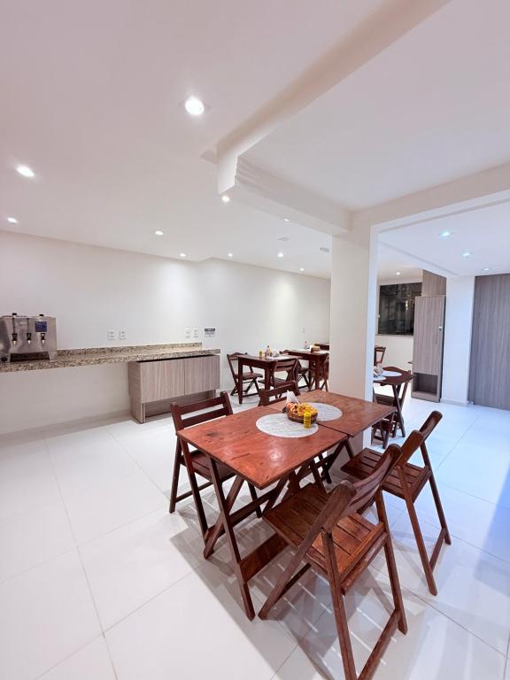 a dining room with wooden tables and chairs at Vila do Morro Pousada in Morro de São Paulo