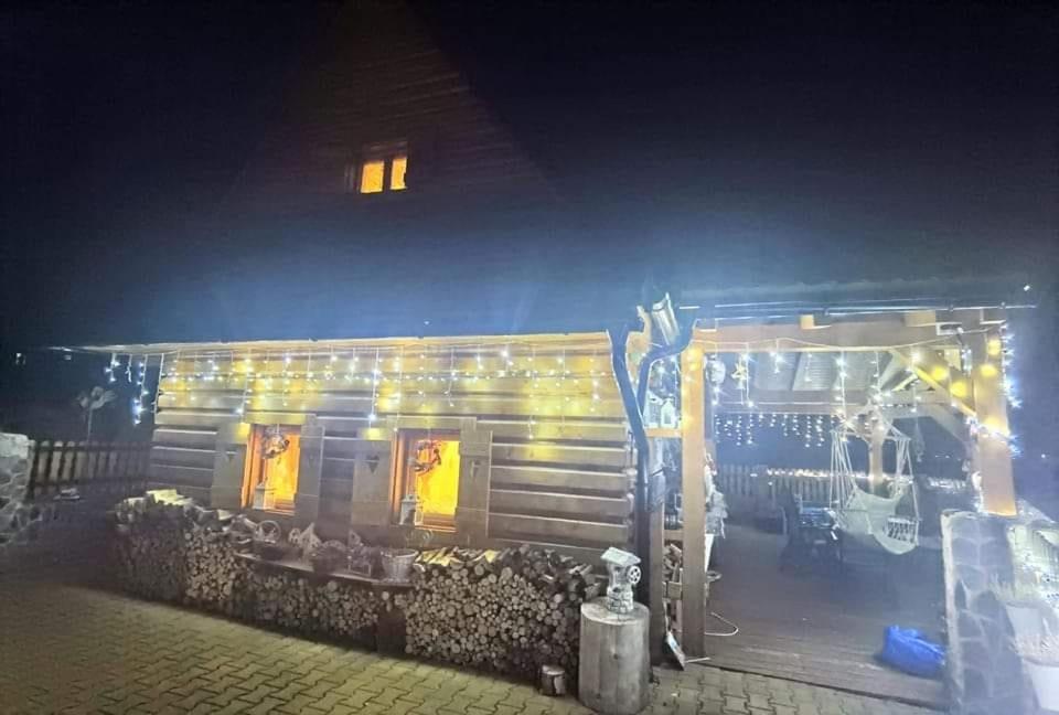 a wooden house with lights on it at night at Chalupka u macka in Párnica
