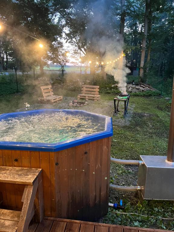 a hot tub in the yard with smoke coming out at Ader puhkemaja in Kogula