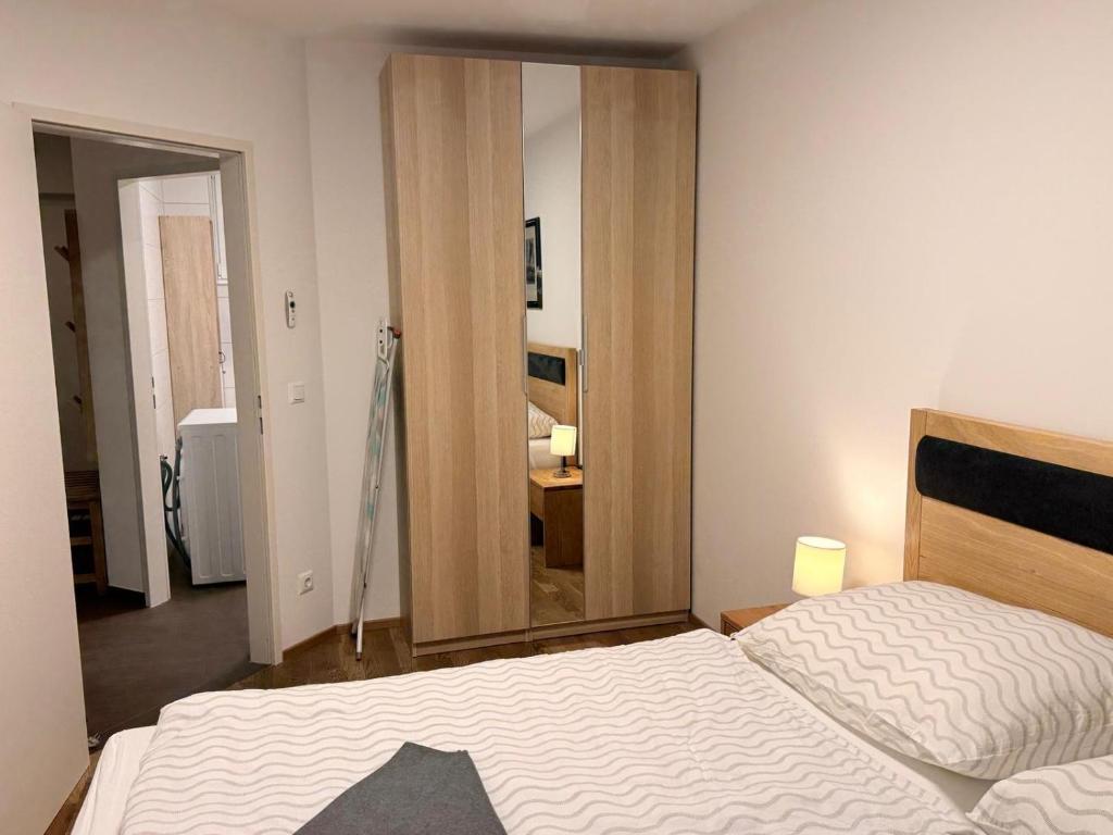 une chambre avec un lit et un grand miroir dans l'établissement Alpenblick 2, à Größing