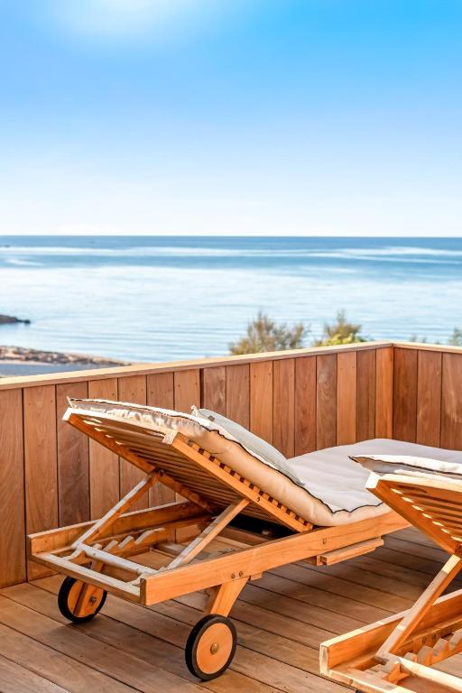 a wooden cart sitting on a deck near the beach at Boutique hôtel Château Rouher in Propriano