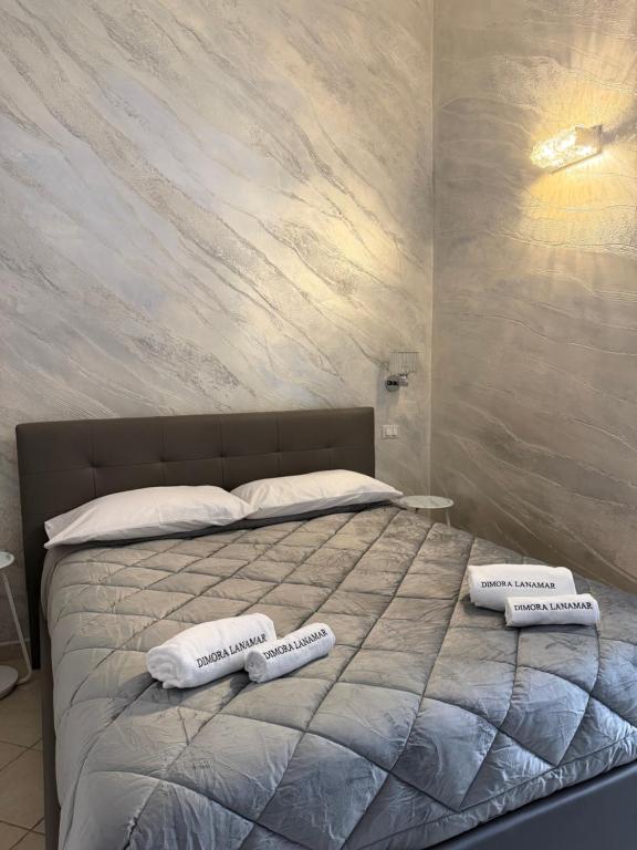 a bedroom with a bed with two pillows on it at Dimora Lanamar in Conversano