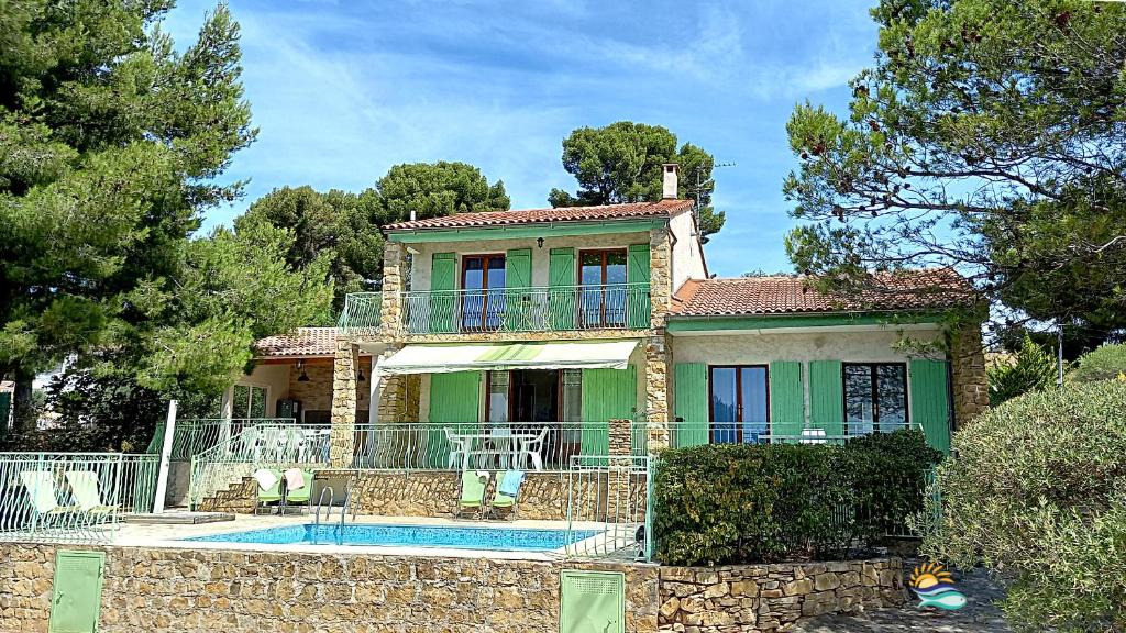 a house with a swimming pool in front of it at villa Terre Brûlée in Ceyreste