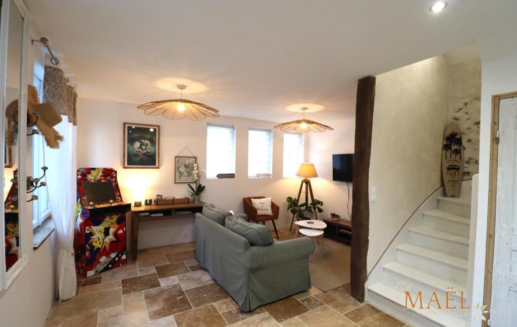 un salon avec un canapé et un bureau dans l'établissement Les Gites de Mael et Rose, à Plougasnou