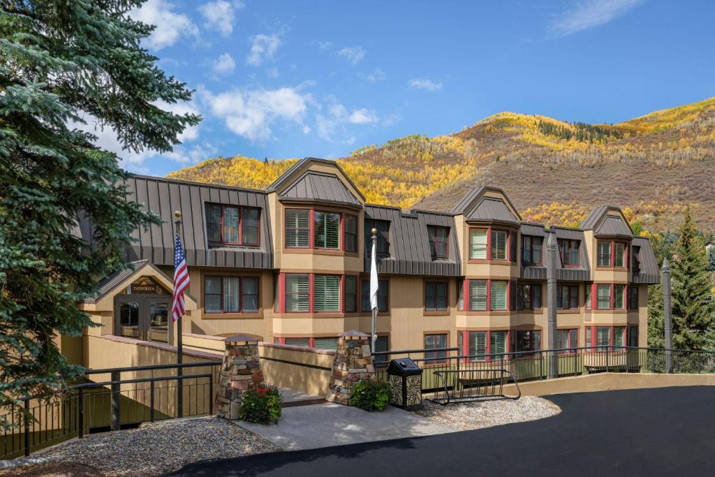 a large apartment building with mountains in the background at Marriott's StreamSide Evergreen at Vail in Vail