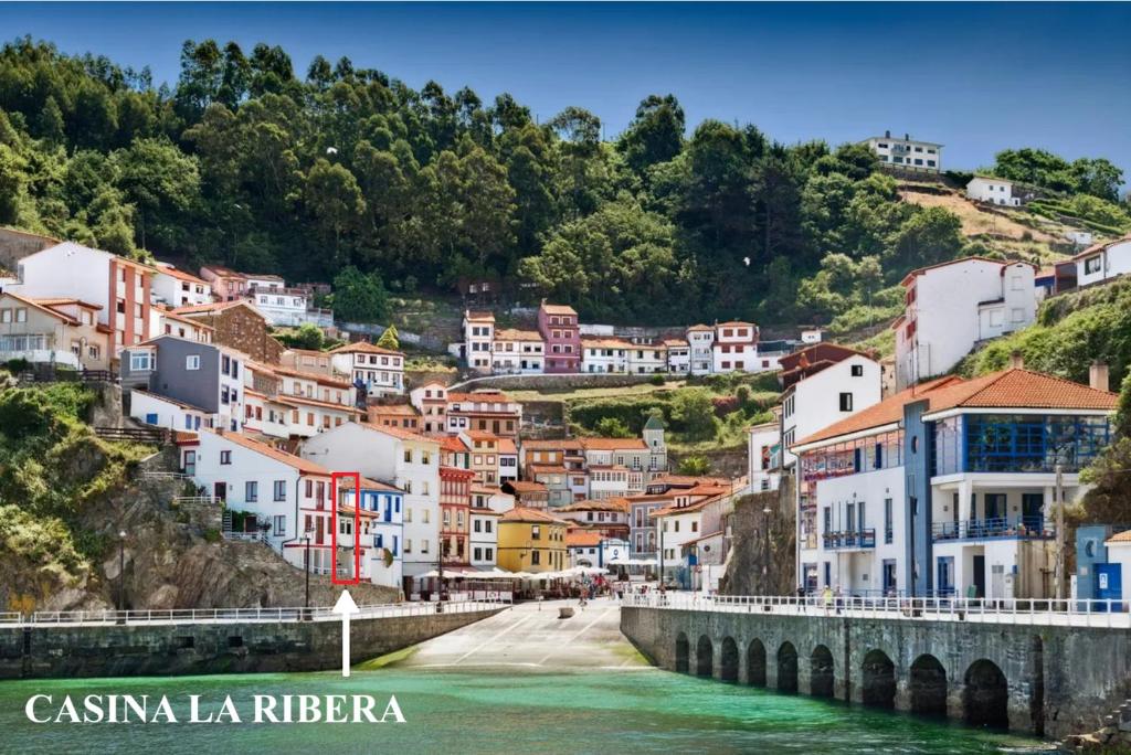 a view of a town with a bridge over a river at CASINA La RIBERA in Cudillero