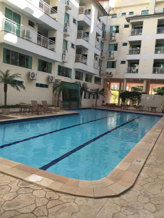 a large swimming pool in front of a building at Apartamento privado no Bombinhas Summer Beach in Bombinhas