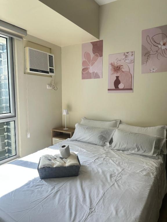 a large white bed in a bedroom with a window at Modern Studio IT Park Fast Wi-Fi, Pool,Netflix in Sampong