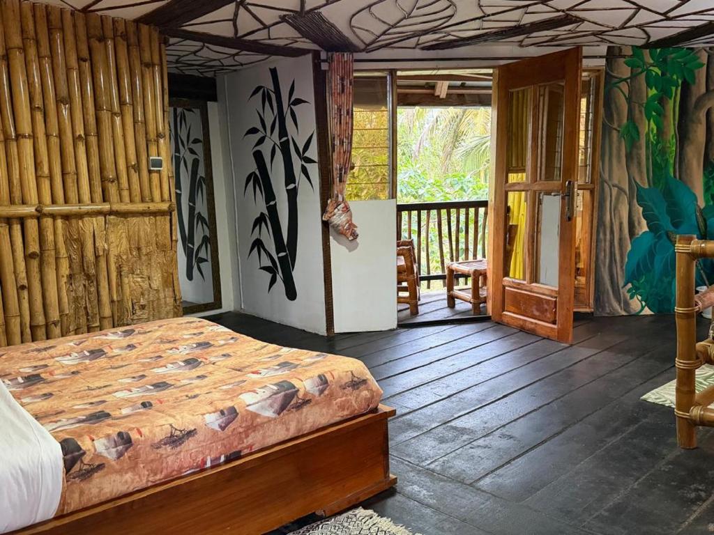 una camera con un letto su un pavimento in legno di Paradise Camp 