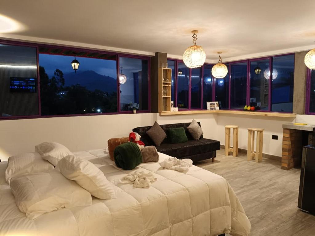 a bedroom with a large bed and a living room at La Marteja in Salento